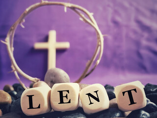 Lent Season, Holy Week and Good Friday Concepts. LENT on wooden cubes with blurry cross and crown...