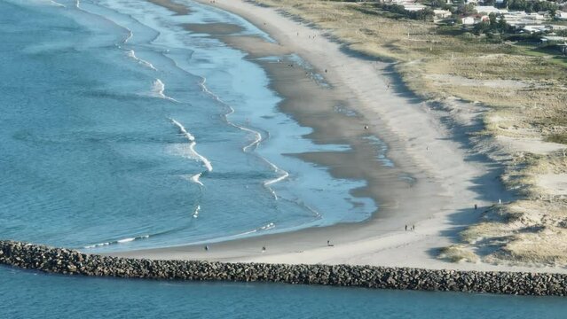 Aerial: Beach and sandspit in the holiday town of Omaha, near Warkworth, New Zealand