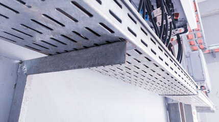Installation metal cable tray on the wall of power control room.
