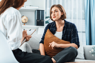 Happy patient and psychologist have mental health conversation in clinic with positive emotion...