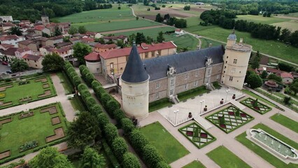 drone shot over the chateau de boutheon with the plaine du forez in the background on a summer sunny day, Andrezieux Boutheon, Loire departement, France