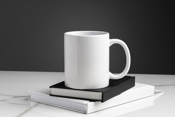Ceramic mug on marble table on gray background