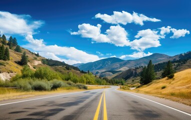 Tranquil Mountain Road with a Clear Blue Sky and Cottony Clouds