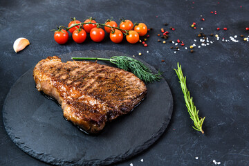 Grilled beef steak ribeye rare on on dark background
