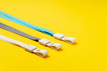 Badge strings on yellow background close up