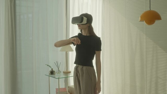 A young woman swipes, scrolls, and types while wearing her VR headset