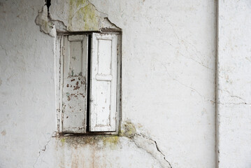 Old white wooden window on the white wall