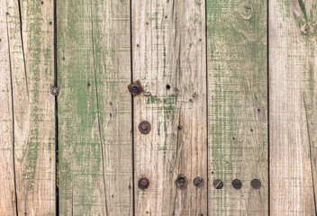 Old wooden boards in green paint as an abstract background. Texture