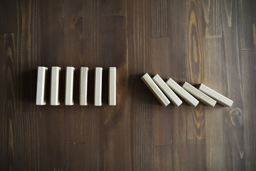 Closeup thick domino wood block in a row stop the falling, be stable in crisis, business solution...