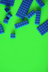 A scattering of constructor elements for children. Colored blue bricks from the puzzle.