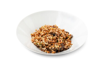 Buckwheat with mushrooms in a white plate. Isolated.