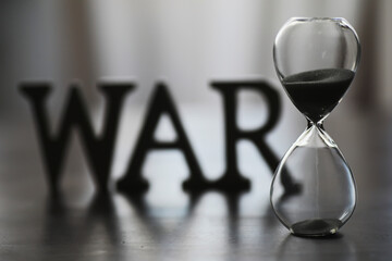 WAR, word written in wooden alphabet letters on blue background. The concept of a terrible war...