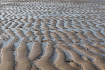 Water on rippled sand on a beach - texture, pattern