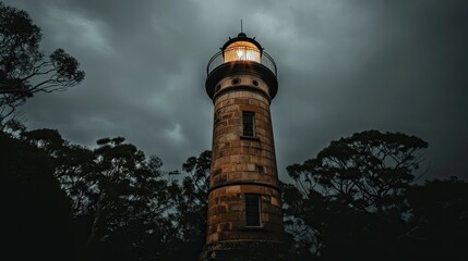 Obraz premium A historic lighthouse shrouded in mist, evoking a sense of mystery and adventure.