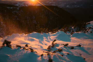 Beautiful landscape with snowdrifts in magic sunset