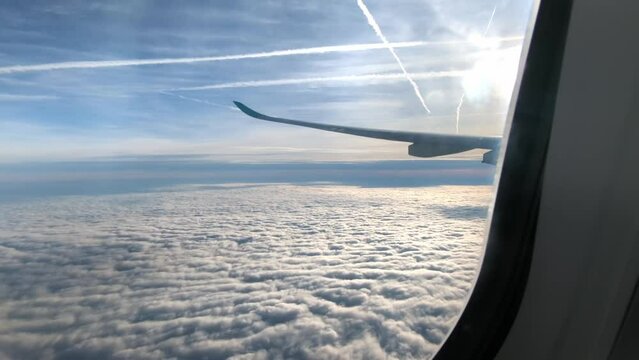 Wing Of Airplane Flying Above Clouds - View From An Airplane Window - POV