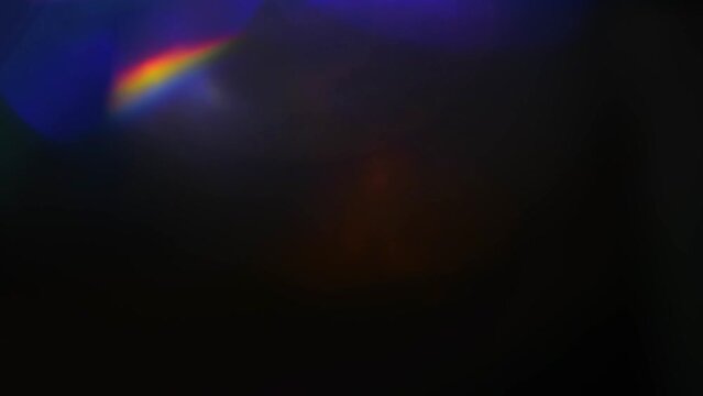 Iridescent highlights, rainbow glare on a black background to overlay and create a bright, sunny and interesting picture, abstract background