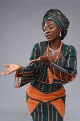 Young black lady looking towards left direction Yoruba Nigerian African looking gorgeous woman lady wearing native attire 