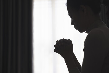 Silhouette of a person praying to god and holy things, religious concept, faith and belief, religious.