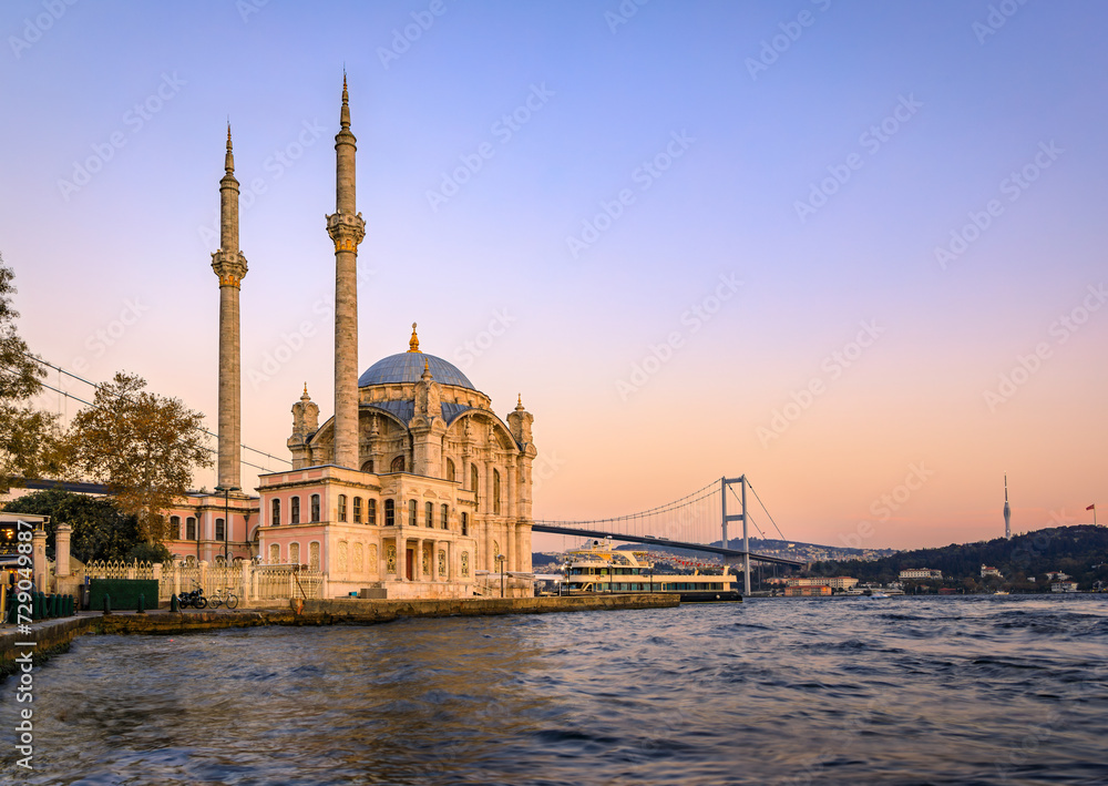 Wall mural Picturesque cityscape with the Bosphorus Strait and the Grand Mecidiye Mosque Ortakoy Mosque and the Bosphorus Bridge Istanbul, Turkey at sunset