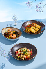 Summer udon and tokpoki set against a blue sky background with delicate flowers