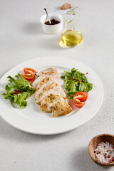 Grilled chicken breast with vibrant salad garnish on a minimalistic white setup, perfect for clean eating and diet concepts