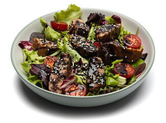 tuna steak salad with sesame seeds and teriyaki sauce in a ceramic bowl