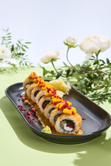 Sushi tempura roll with tuna filling and mango sauce in a surreal, eco-friendly floral environment