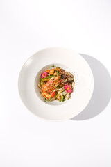 Top View of Zucchini Seafood Sauté with Shrimp and Floral Garnish