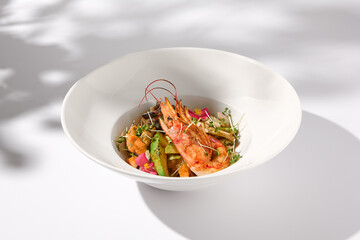 Zucchini Seafood Sauté with Shrimp and Elegant Floral Garnish on Shadowed White