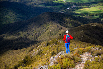 hiker girl walking down the steep trail from the top of mount somers in canterbury, new zealand south island © Lens Down Under