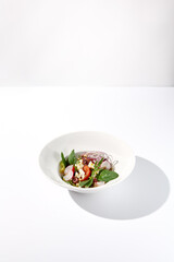 Greek salad isolated on a white background with crisp vegetables and feta cheese