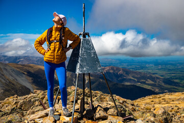backpacker enjoying the stunning panorama of new zealand alps from the top of mount somers in...