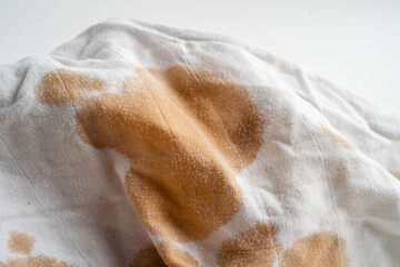 Dirty sauce stain on cloth to wash with washing powder, cleaning housework concept.