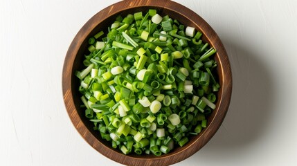Finely chopped fresh scallions are elegantly arranged on a clean white background. This composition emphasizes the green stems and white heads of the onions. and appetizing