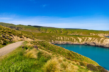 panorama of tumbledown bay in banks peninsula near christchurch, canterbury, new zealand south...