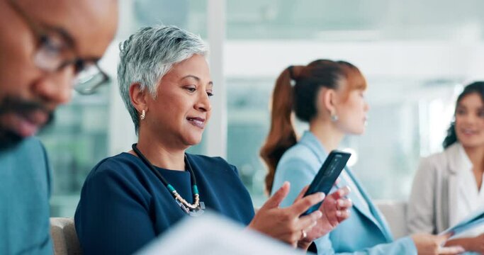 Senior, woman and phone with business people in office for communication, reading text message or notification. Mature, person or entrepreneur with smartphone in boardroom for mobile chat or internet