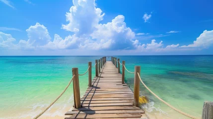 Fototapeten A wooden bridge jutting out into the sea. There is a pristine white sand beach. green sea water There is bright, high quality morning sunlight. © panu101