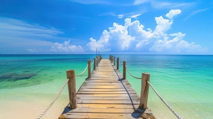  A wooden bridge jutting out into the sea. There is a pristine white sand beach. green sea water There is bright, high quality morning sunlight. © panu101
