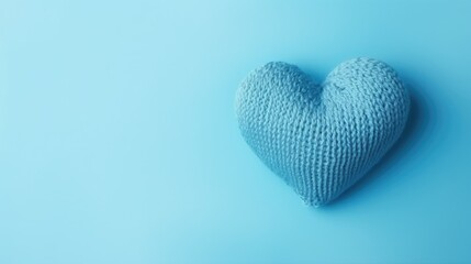 A blue knitted heart on a blue background, top view, with space for text. Valentine's Day, hobbies, knitting, love, health concept.