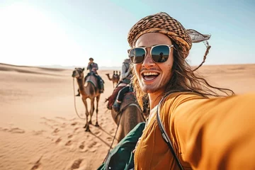 Foto auf Leinwand Happy tourist having fun enjoying group camel ride tour in the desert - Travel, life style, vacation activities and adventure concept, Generative AI © Pixel Nirvana
