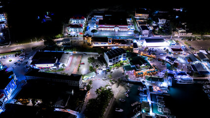 Beautiful scenic aerial night view of the Caribbean island of St Maarten. Boats and yacht docked at...