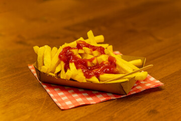 paper bowl with french fries and ketchup