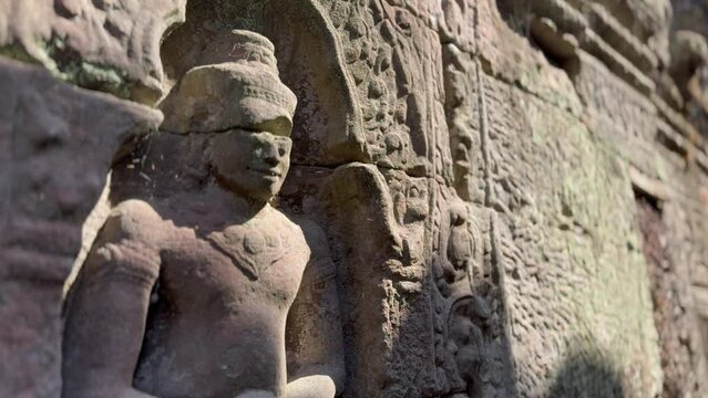 Close-up shots of statues carved into the walls of an isolated temple in the jungle. Filmed at Ta Som at the Angkor site in Cambodia. This footage is part of a large collection on the Angkor temples. 