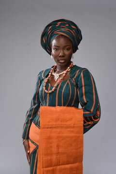Young black lady facing camera Yoruba Nigerian African looking gorgeous woman lady wearing native attire 