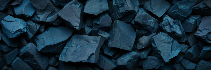 Close-up texture of a dark, fragmented, rock surface, suitable for abstract backgrounds or geological concepts