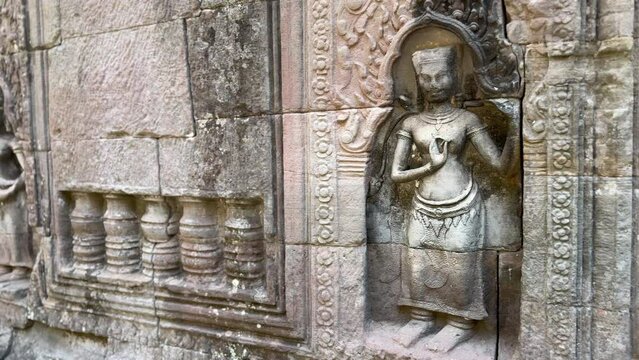 Panoramic view of the statues and entrance of an isolated Khmer temple in the jungle. Filmed at Ta Som at the Angkor site in Cambodia. This footage is part of a large collection on the Angkor temples.