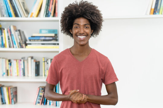 Laughing black male young adult with amazing hairstyle