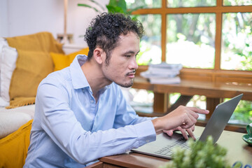 Portrait male professional entrepreneur business man manager sitting indoor working laptop computer smiling, adult business man person looking happy cheerful confidence online internet occupation