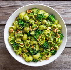 Pasta with broccoli, pesto sauce and nuts. Italian cuisine. Healthy eating.